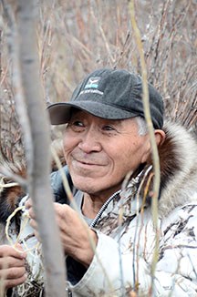 Raymond Paneak, of Anaktuvuk Pass, sets a ptarmigan snare.