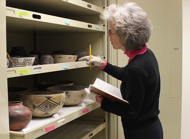 Volunteer working with archeological collections at Aztec Ruins