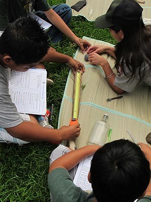 Ranger Summer Roper assists students with their analysis and recording observations. NPS Photo.