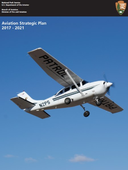 A white plane flies across the blue sky