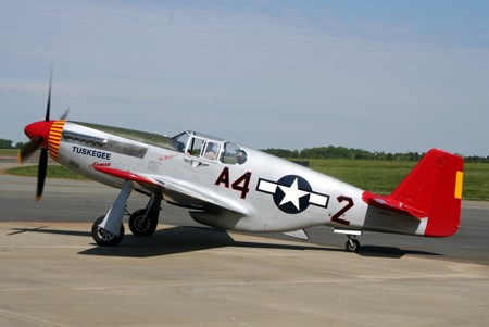 Red Tail of Tuskegee A silver plane with a red tail and elevator