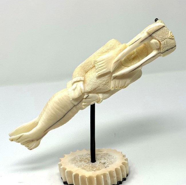 ivory carving of man transforming into walrus