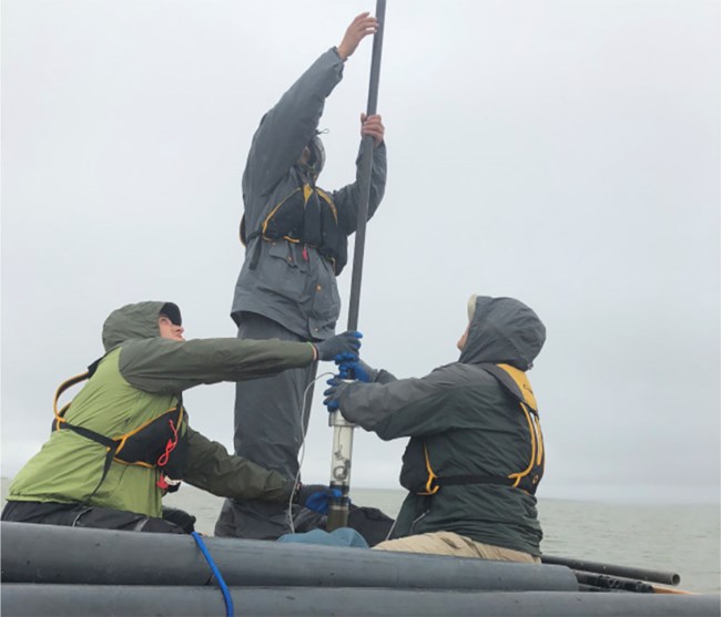 taking sediment cores People on a raft taking sediment cores