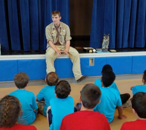 Caleb talking to a group of young children