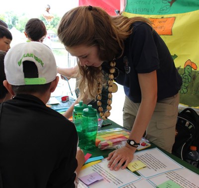 Katherine teaching young children how to play a game about biodiversity