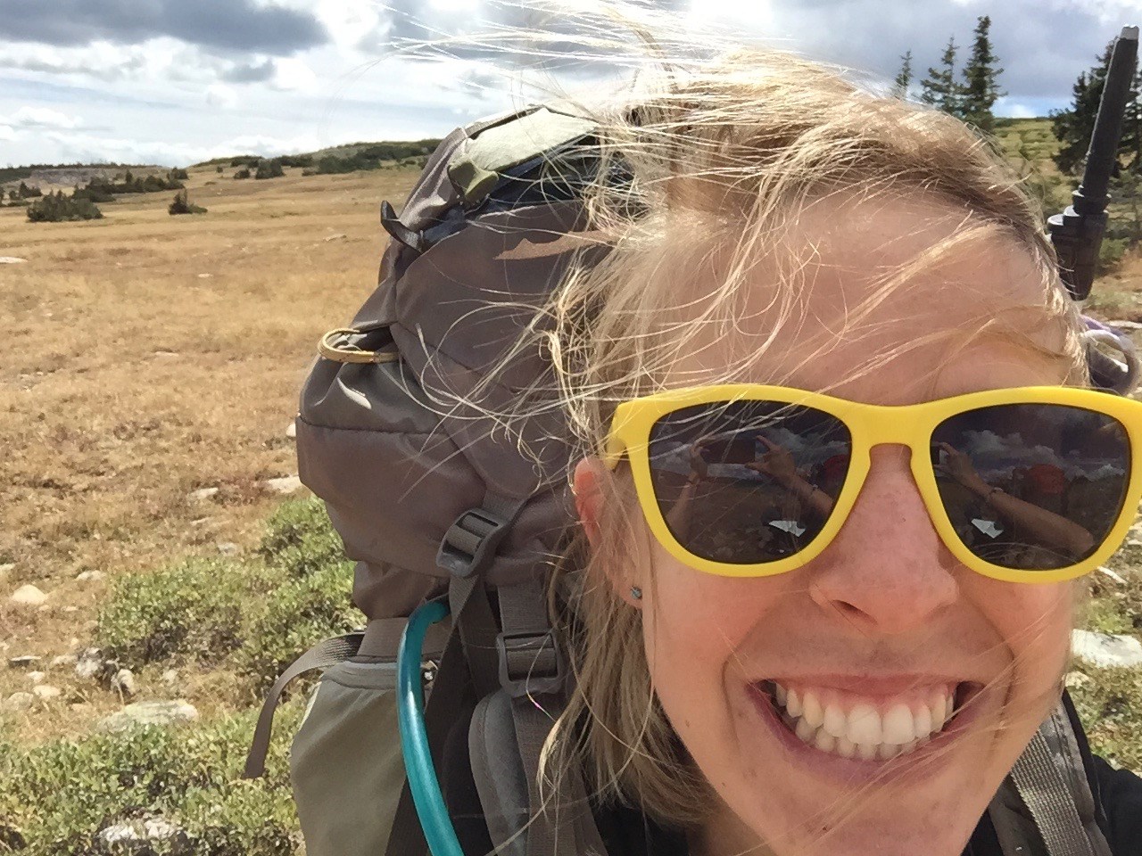 close up selfie of a smiling girl backpacking