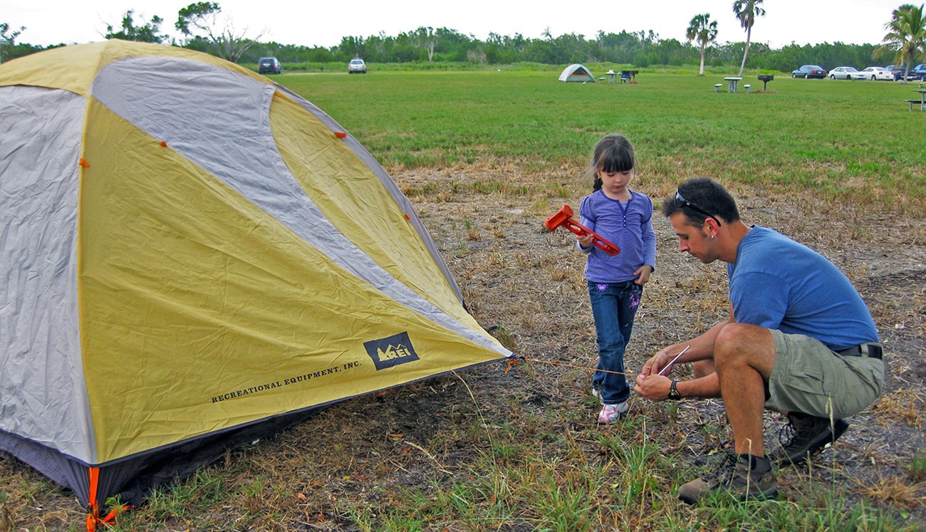 Perez 1 Flamingo_cropped man and young girl set up a yellow tent