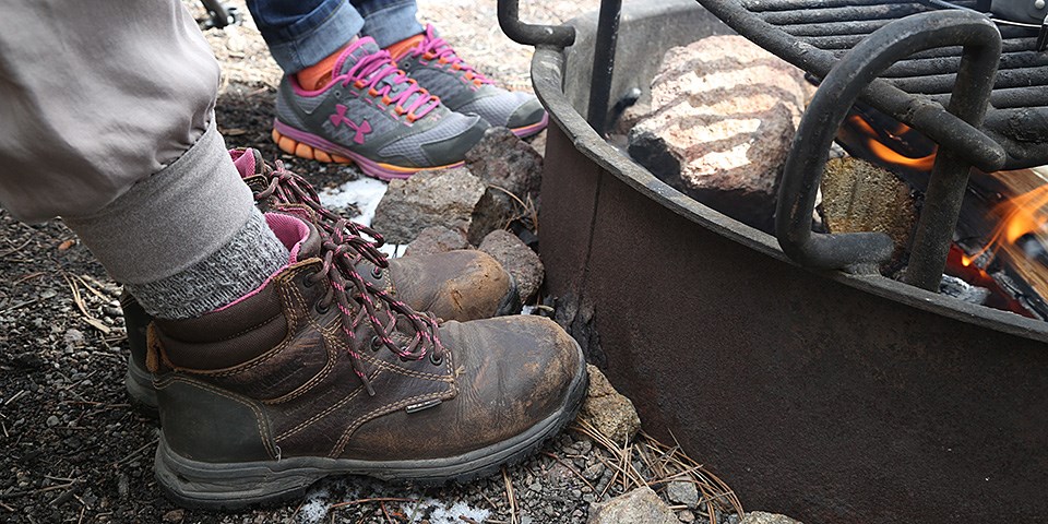 Feet warming next to a campfire