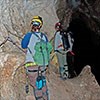 cavers on narrow ledge