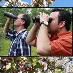 River Fest visitors looking through binoculars