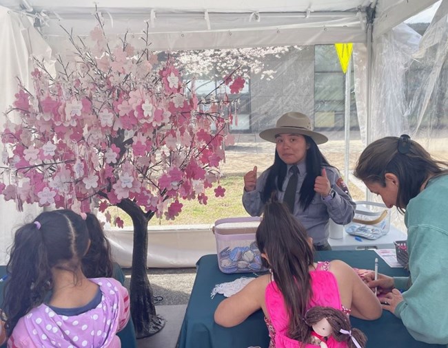 Park ranger conducting cherry blossom activity with kids