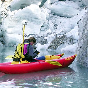 Woman in kayak measuring the end point of a glacier