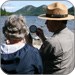 Ranger and visitor talking near lake
