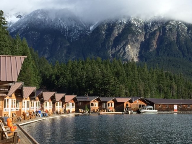a row of cabins on a lake