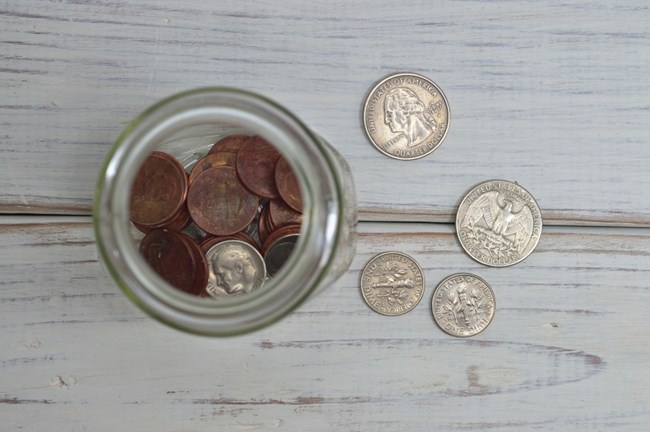donation coins in a jar and on a table
