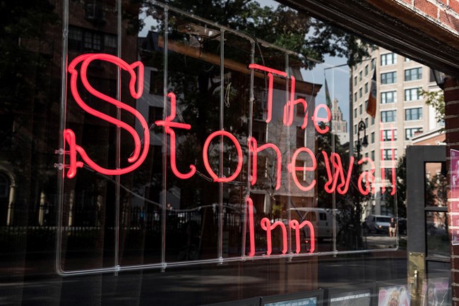 Neon Stonewall Inn sign in window