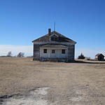 School District #1 Nicodemus School, surrounded by flat, open landscape