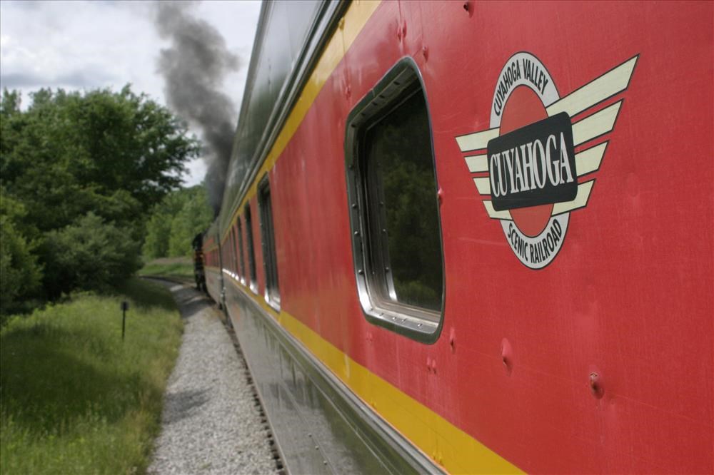 Smoke rises from a train as it follows tracks through the Cuyahoga Valley