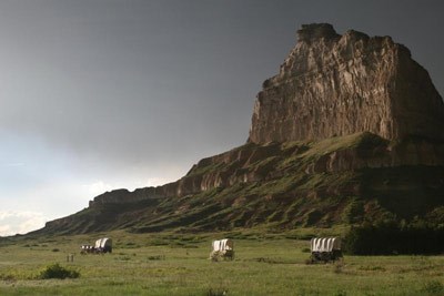 lt= Replica wagons and Eagle Rock at Scotts Bluff