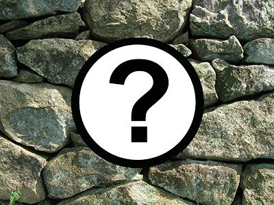 Image of a question mark in front of a stone wall