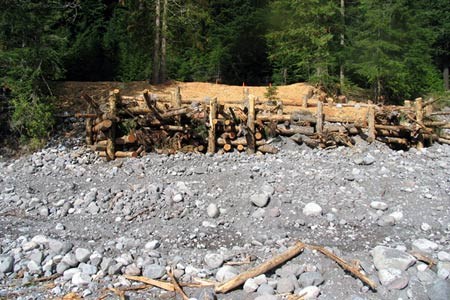 Log structure protecting Nisqually Road A structure of logs on a rocky embankment in Mount Rainier National Park