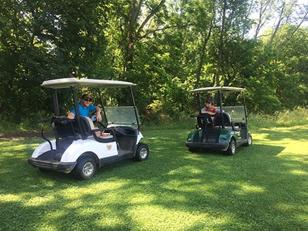 Two University of Pennsylvania graduate students conduct fieldwork using golf carts at East Potomac Park