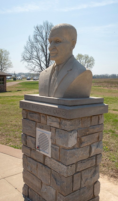 A bust of George Washington Carver on a stone pedestal