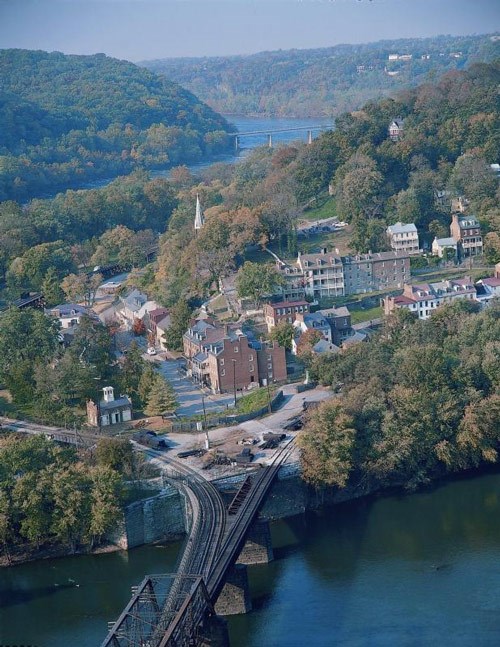 lt= Aerial view of Harpers Ferry, showing the town surrounded by rivers and hills.