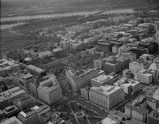 An aerial image of the urban fabric of downtown Washington DC, with McPherson and Lafayette Squares kitty-corner to one another.