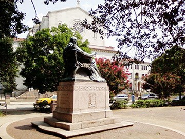 A view from the west side of the memorial statuary. Trees and the Shrine of the Sacred Heart lie beyond across the street.