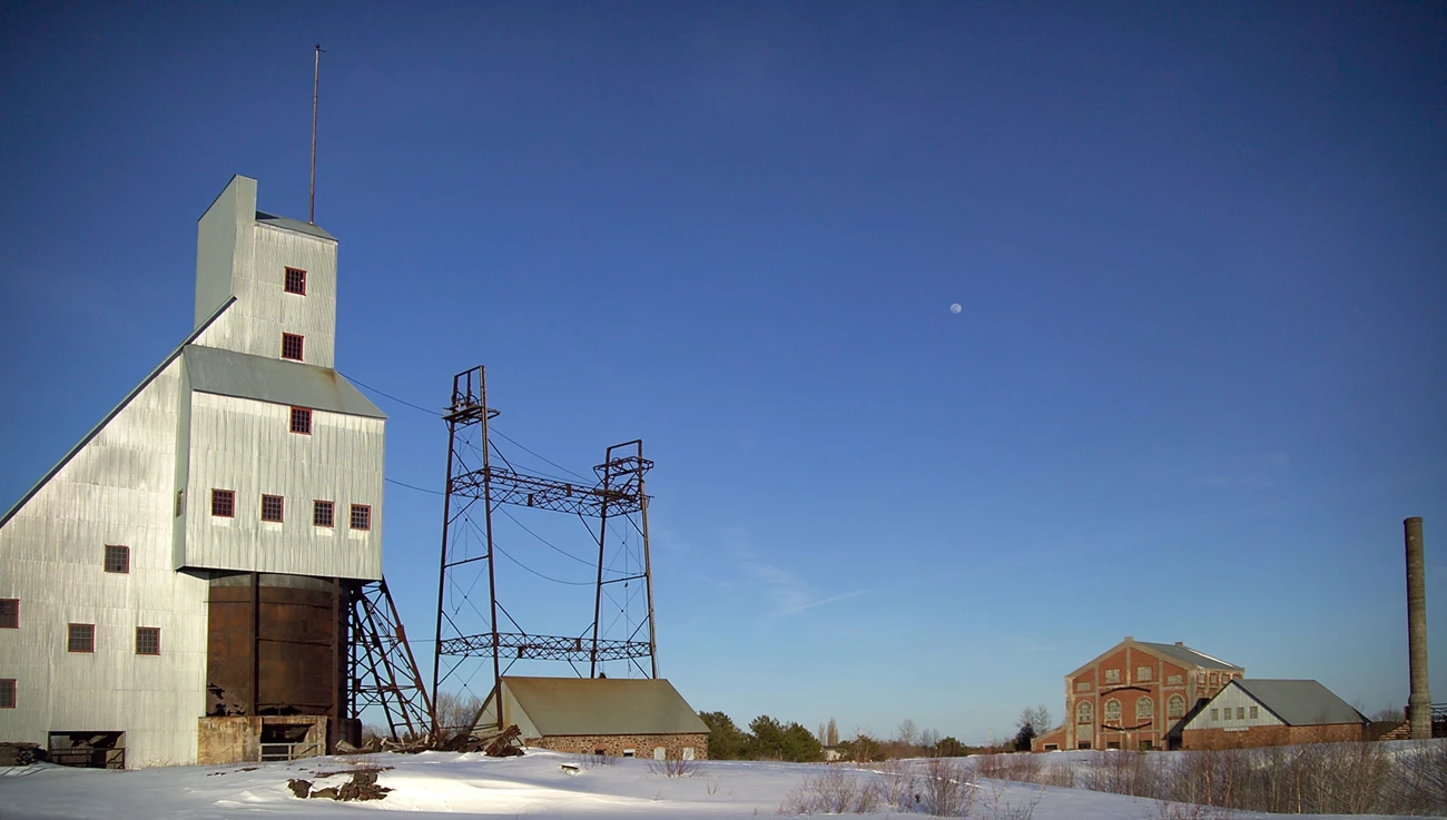 Quincy Mine landscape in winter Snow covers the site of the former Quincy Copper Mine The No. 2 shaft-rockhouse , metal and wire of the pulley stands, and large brick hoist house with smoke stack are spaced in a level area