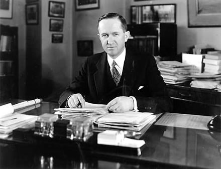 Albright at desk - WASO A man in a suit and tie sits behind a desk
