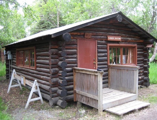 KATM Brooks Camp Ranger Station A one-story structure with saddle-notched logs, a small wooden porch, and a Ranger Station sign