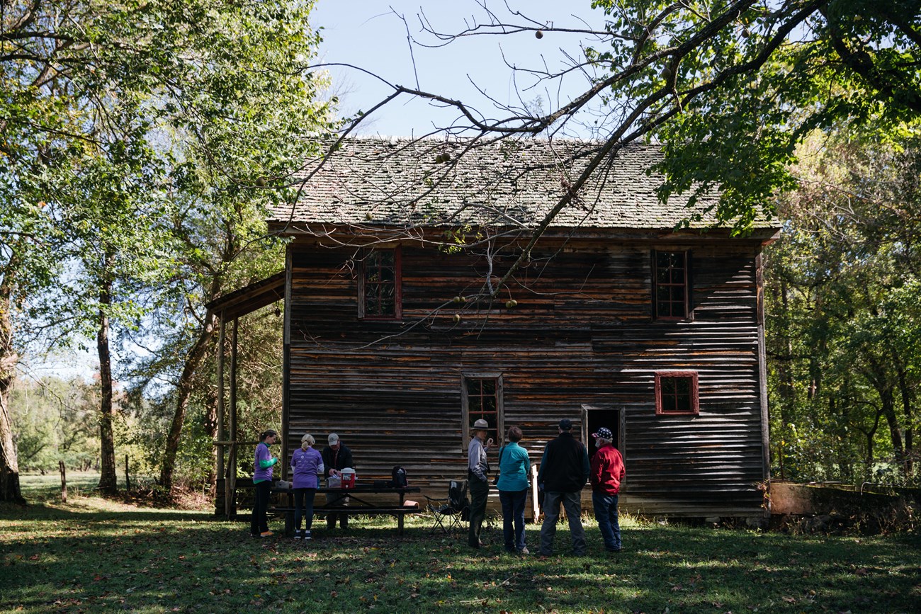 A ranger speaks with a group of people outside of the historic Boxley Grist Mill in Boxley Valley Historic District
