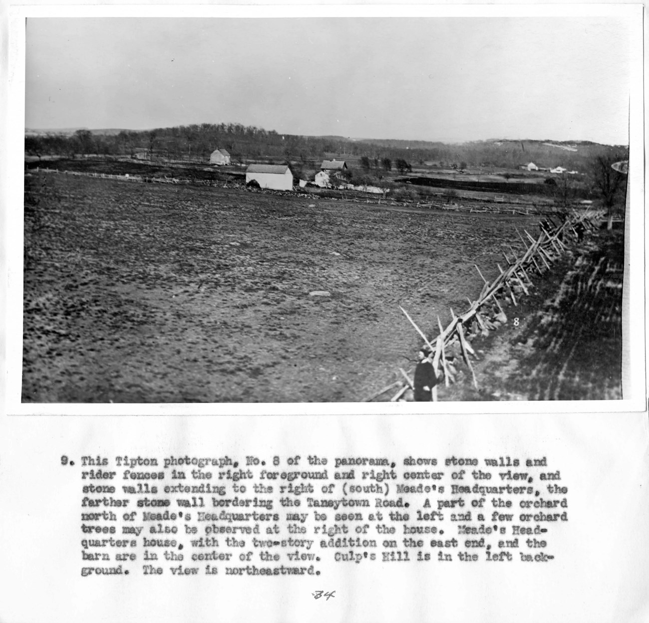 Tipton Photograph No. 8, Gettysburg Historic photograph shows a rider fence and stone walls along the edge of a field, with structures and trees in the background.