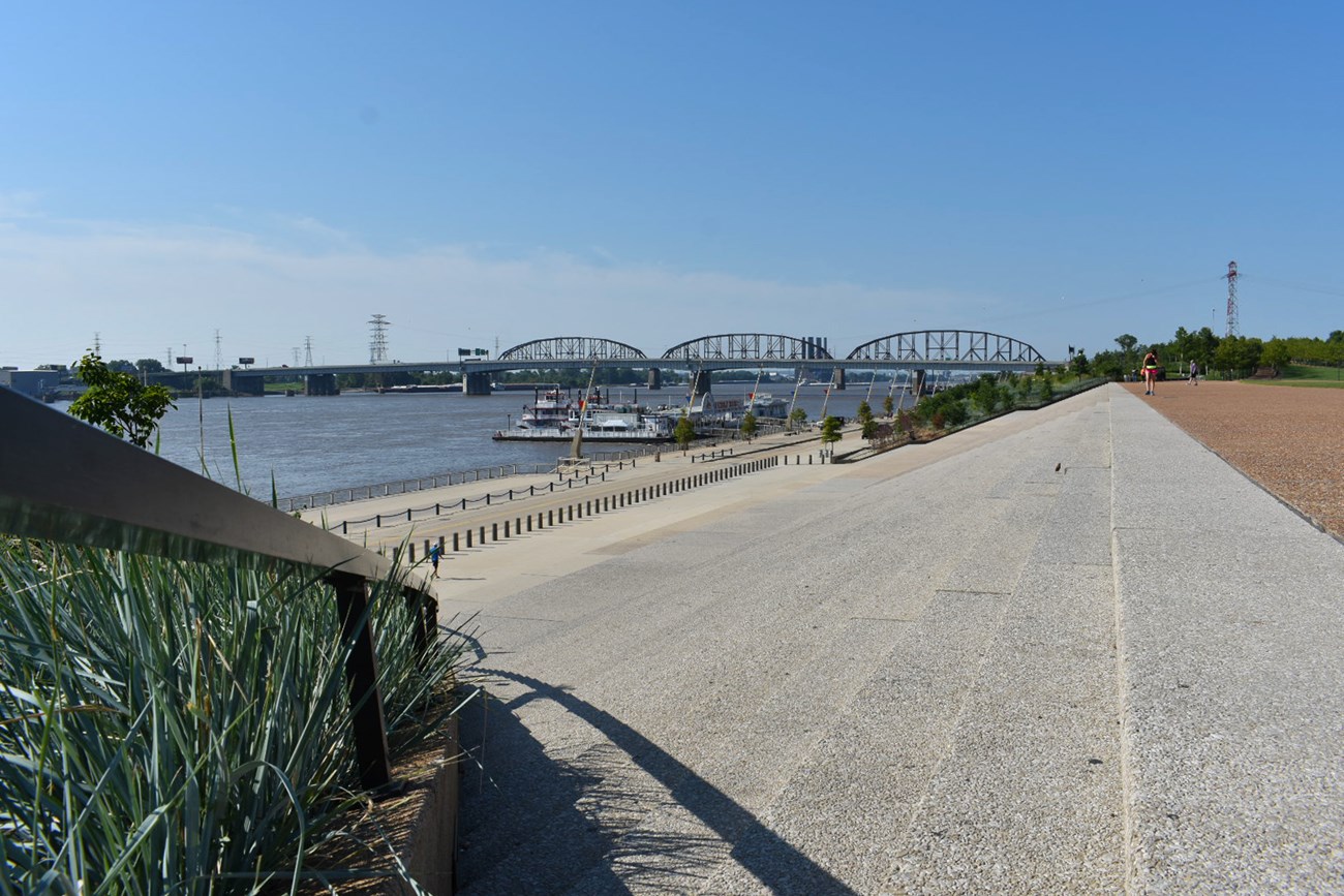 A broad staircase leads to a walkway along the Mississippi River