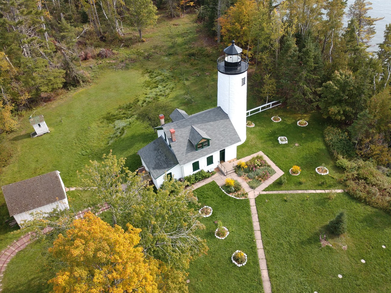 Michigan Light Station landscape overhead Overhead view of the old Michigan Lighthouse landscape, with tram tracks leading in from the left, walkways and gardens, and a perimeter of trees