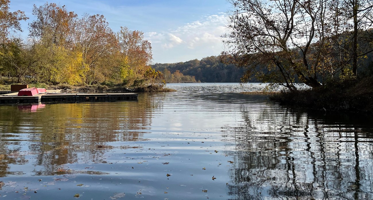 CHOH Fletcher's Cove Color photo of Fletcher’s Cove looking out to the Potomac River with a boat dock on the left and the tree line on the Virginia shore in the background