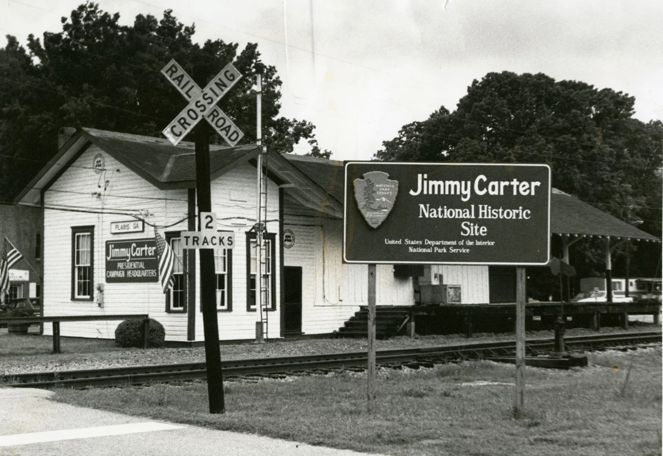 JICA Depot in 1988 An NPS sign beside the one-story train depot and tracks says "Jimmy Carter National Historic Site"