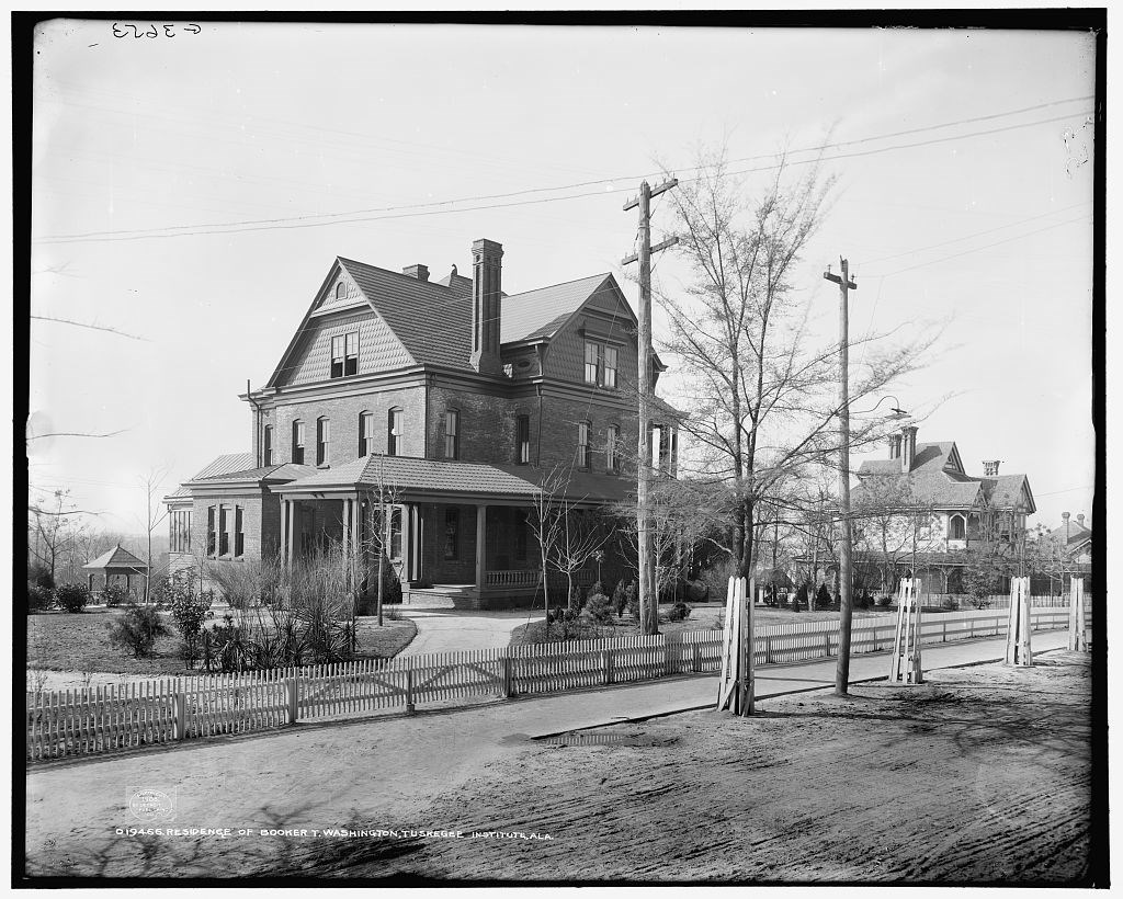 The Oaks, 1906 A picket fence surrounds the landscaped yard of a two-story house.