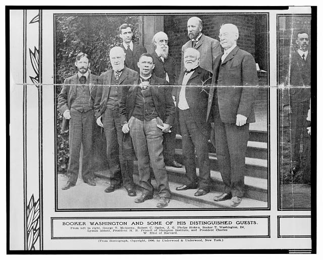 Booker T. Washington and Guests Booker T. Washington, standing center, with George T. McAneny, Robert C. Ogden, an unidentified man, George W. Eliot, J.G. Phelps Stokes, Dr. Lyman Abbott, and Hollis B. Frissell.