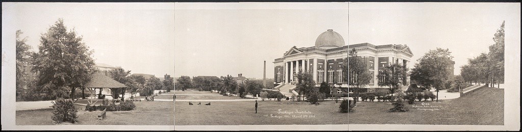 A panorama of the campus landscape shows a gazebo, grass sections, and a large rectangular building with columns.