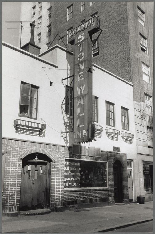 A 1969 photo of the Stonewall Inn shows the front of the two-story structure, empty flower boxes under the windows, and vertical "Stonewall Inn" sign