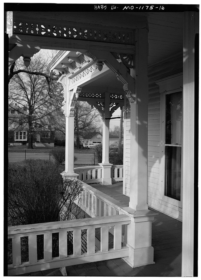 Detail of west porch, Harry S. Truman House A view towards a street from a porch that wraps around the side of a house.