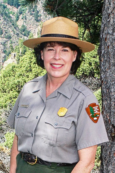 Connie Rudd poses outside in NPS uniform and flathat
