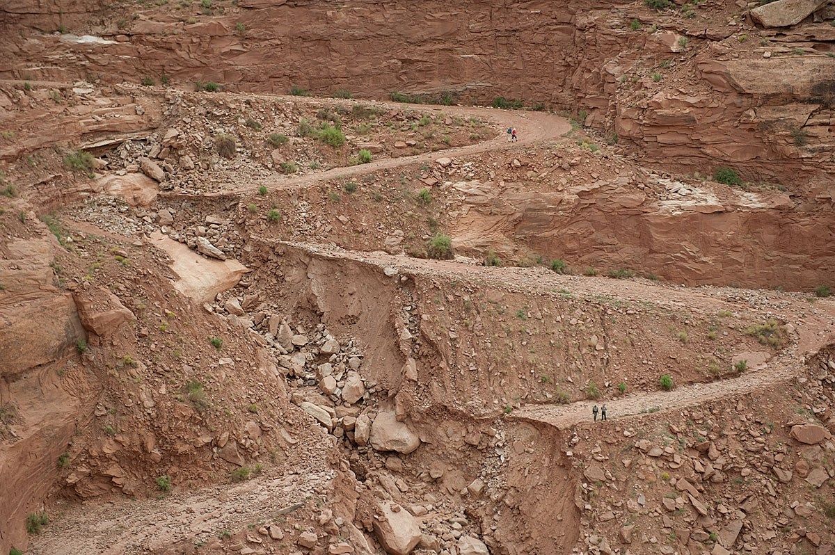 dirt road switchbacks cutoff by large eroded gullies