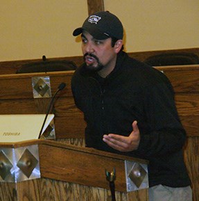 Man speaking at a podium.