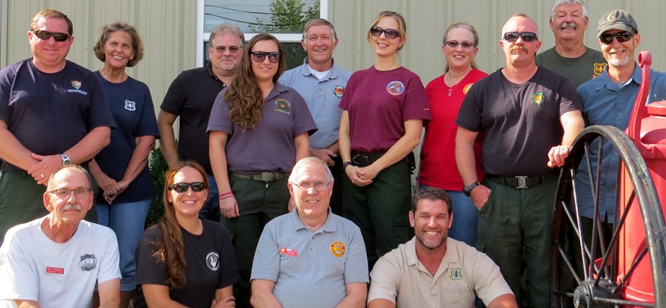 Multi-Agency Incident Management Team (IMT) Men and women wearing a variety of agency shirts pose in a group.