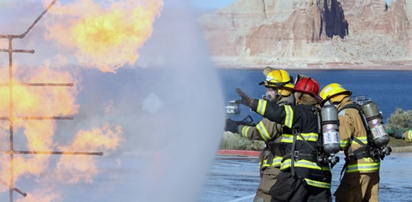 Firefighters in PPE fighting a propane fire.