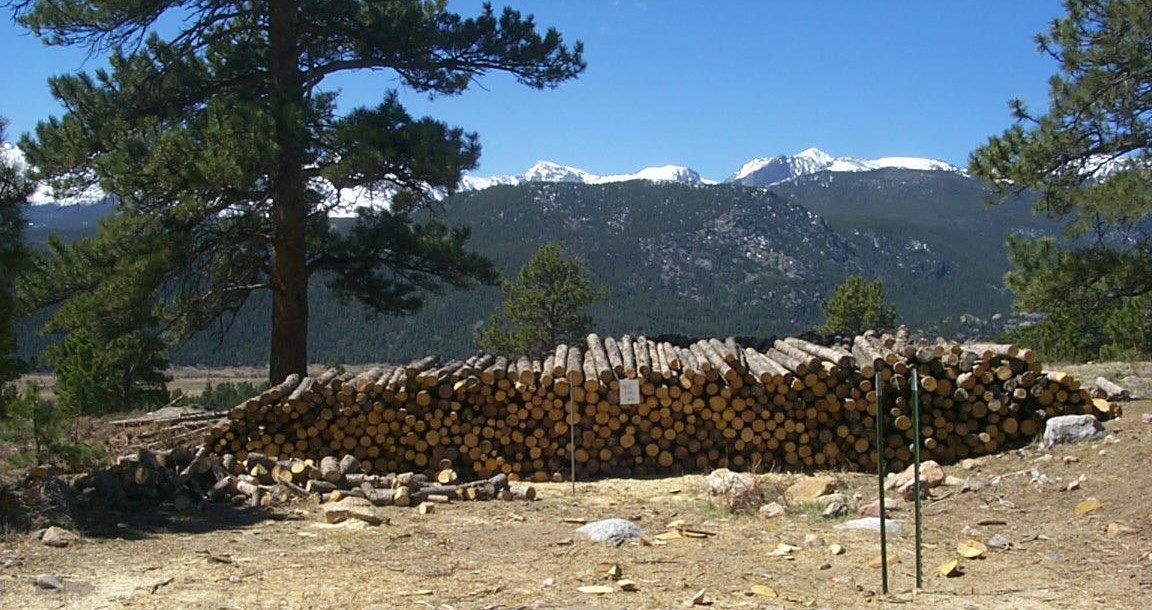 A very large stacking of logs.